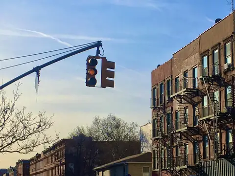 A Bedford-Stuyvesant corner building in Brooklyn with shops on the ground floor and apartments above