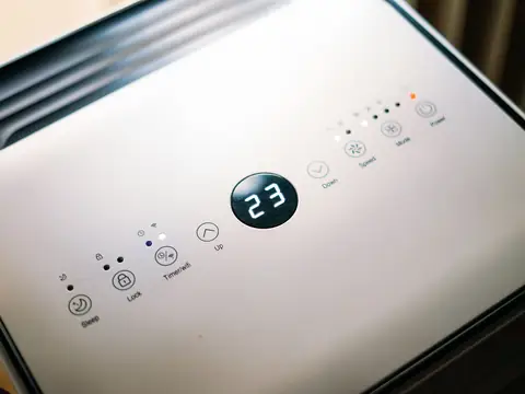 The control panel of a portable dehumidifier, its display reading 23