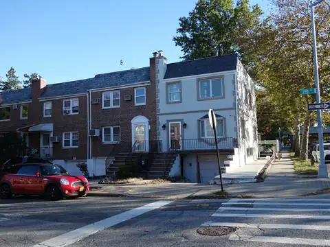Attached brick two-family houses on a corner in Fresh Meadows, Queens