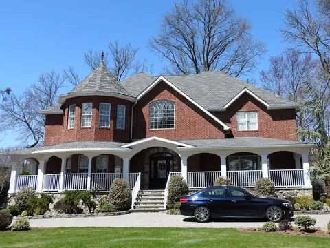 A large shingled house with a wraparound porch on Meisner Avenue, Staten Island